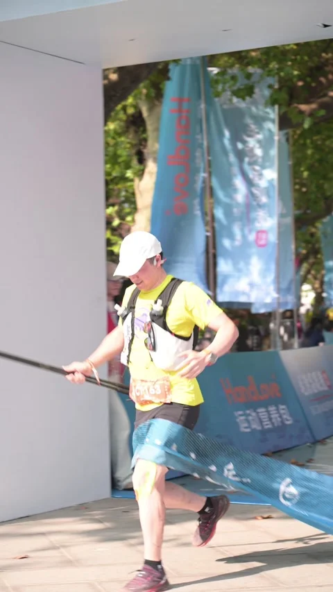 Male Runner with White Cap Arms Wide Crossing Finish Arch, Lushan Stock Footage 346717181