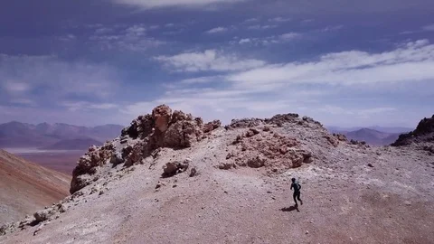 Male running down summit a volcano Stock Footage 84157855