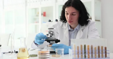 Male scientist examines elements with microscope in office Stock Footage 275578278