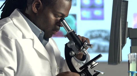 Male Scientist Looking through Microscope - Pan and tilt Stock Footage 41795819