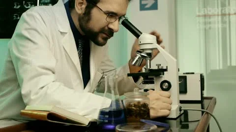 Male Scientist On Microscope (HD) Stock Footage