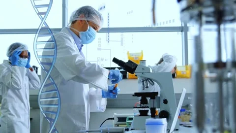 Male scientist pipetting sample for analysis at lab, team donning PPE, DNA helix Stock Footage 333425894