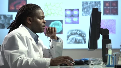 Male Scientist using Computer - pan and tilt 動画素材 41795926