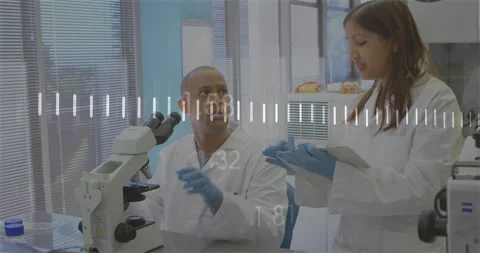 Male scientist using microscope, female researcher scrolling tablet, inquiring Stock Footage 313758839