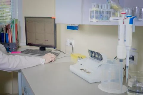 Male scientist is working on a computer in a laboratory. Stock Photos