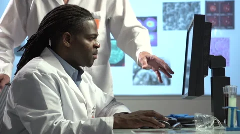 Male Scientists at computer - Pan and tilt Stock Footage 41795648