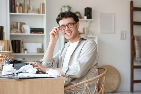 Male screenwriter using typewriter at table in office Stock Photos