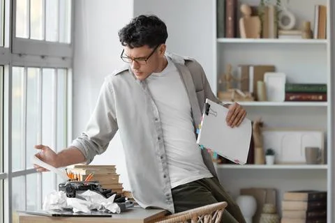Male screenwriter using typewriter on table in office Stock Photos