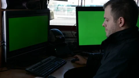 Male Security Guard On Workplace In Action. One monitor with chromakey Видео 99501637