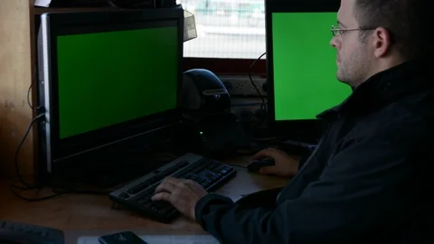Male Security Guard On Workplace In Action. One monitor with chromakey Stock-Footage 99502220