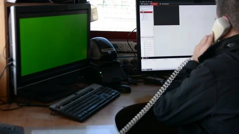 Male Security Guard On Workplace In Action. One monitor with chromakey 動画素材 99503463