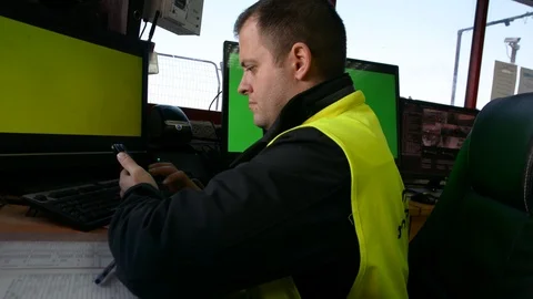 Male Security Guard On Workplace In Action. One monitor with chromakey 스톡 동영상 100660350