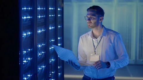 Male Server Engineer in Data Center. IT engineer inspecting a secure server Stock Footage 168228623
