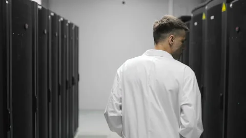 Male Server Engineer Walks Through Working Data Center Full of Rack Servers Stock Footage 92541317