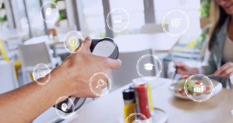 Male server holding terminal while female customer tapping to pay for meal, Stock Footage 321550690