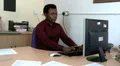 Male sitting at desk is handed more work HD Footage
