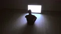 The male sitting on the floor near the television 4k or 4k+ Resolution