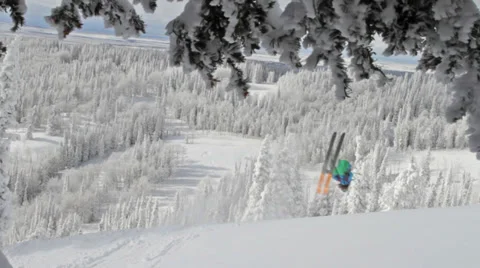 A male skier does a backflip off of a small jump Stock Footage 35044975