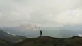 The male with a smoke bomb standing on the mountain top 4k or 4k+ Resolution
