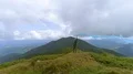 The male with a smoke bomb standing on the picturesque mountain 4k or 4k+ Resolution