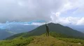 The male with a smoke bomb standing on the picturesque mountain 4k or 4k+ Resolution