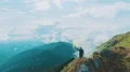 The male with a smoke bomb standing on the picturesque mountain 4k or 4k+ Resolution