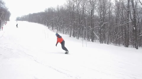 Male snowboarder slides in mountain in winter day. 스톡 동영상 59711908