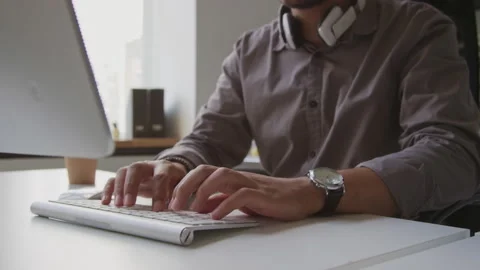 Male Software Developer Typing on Wireless Keyboard Stock Footage 255781066