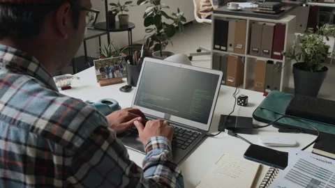 Male Software Engineer Coding on Laptop in Office Stock Footage 285710265