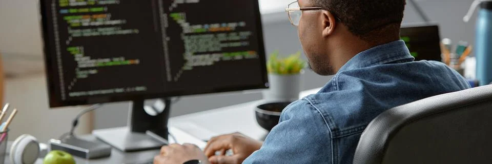 Male Software Engineer Writing Script Sitting at Office Table Stock Photos
