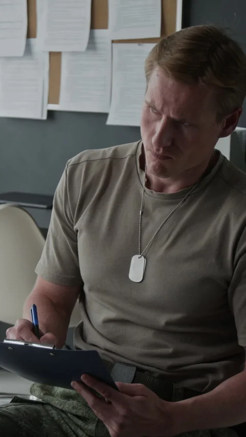 Male Soldier Thinking While Writing on Clipboard in Office Stock Footage 340637782