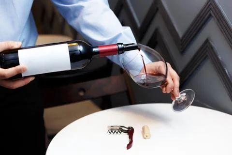 Male sommelier is checking and testing red wine Stock Photos