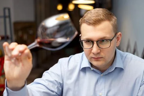 Male sommelier is checking and testing red wine Stock Photos