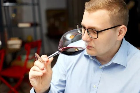 Male sommelier is checking and testing red wine Stock Photos