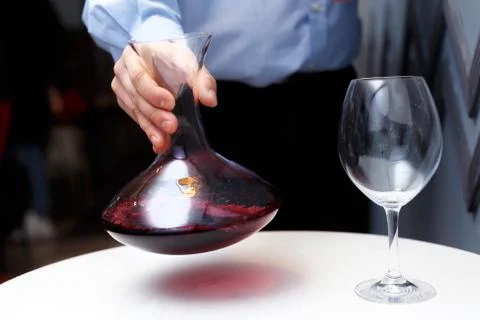Male sommelier is checking and testing red wine Stock Photos