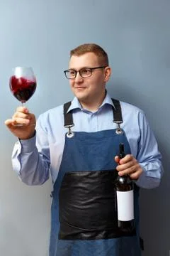 Male sommelier is checking and testing red wine Stock Photos