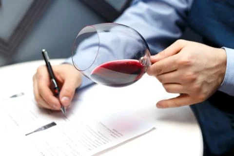 Male sommelier is checking and testing red wine Stock Photos