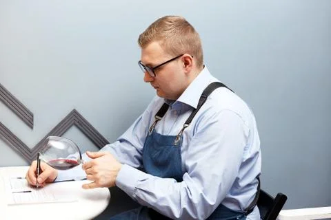 Male sommelier is checking and testing red wine Stock Photos