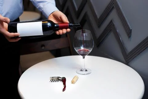 Male sommelier is checking and testing red wine Stock Photos