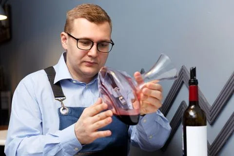 Male sommelier is checking and testing red wine Stock Photos