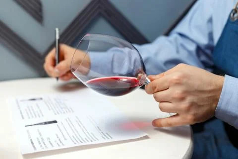 Male sommelier is checking and testing red wine Stock Photos