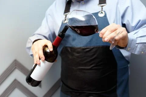 Male sommelier is checking and testing red wine Stock Photos