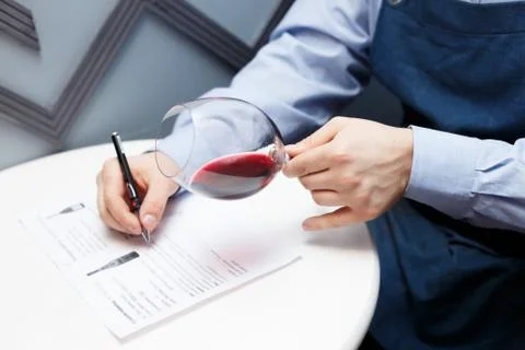 Male sommelier is checking and testing red wine Stock Photos