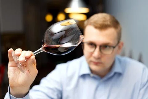 Male sommelier is checking and testing red wine Stock Photos