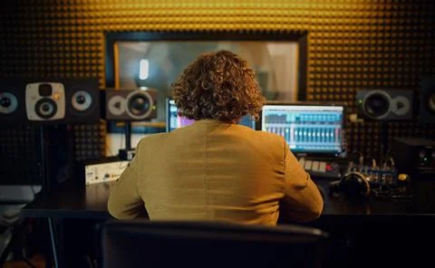 Male sound engineer at mixing consol, back view Stock Photos
