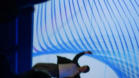 Male Speaker Gets on Stage, Greets Audience and Presents Technological Product Stock Footage 122815074