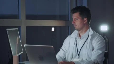 Male specialist in electronics working on the computer in modern lab 写真素材