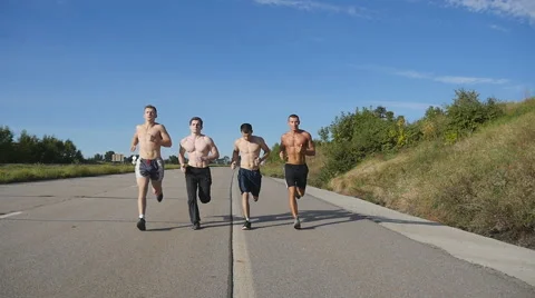 Male sport athletes training outdoor at summer. Slow motion Stock Footage