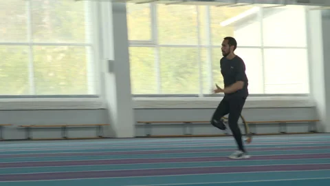 Male Sprinter with Limb Prosthesis Running on Track Stock Footage 259281765