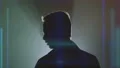 The male standing in the dark on a hologram background 4k or 4k+ Resolution
